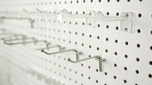 Amoowis metal pegboard panel showing 1/4 inch hole pattern with assorted hooks installed